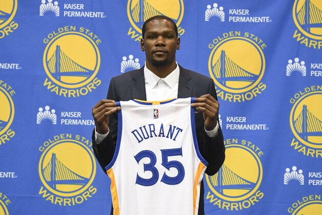 Jul 7, 2016; Oakland, CA, USA; Kevin Durant poses for a photo with his jersey during a press conference after signing with the Golden State Warriors at the Warriors Practice Facility. Mandatory Credit: Kyle Terada-USA TODAY Sports Jul 7, 2016; Oakland, CA, USA; Kevin Durant poses for a photo with his jersey during a press conference after signing with the Golden State Warriors at the Warriors Practice Facility. Mandatory Credit: Kyle Terada-USA TODAY Sports