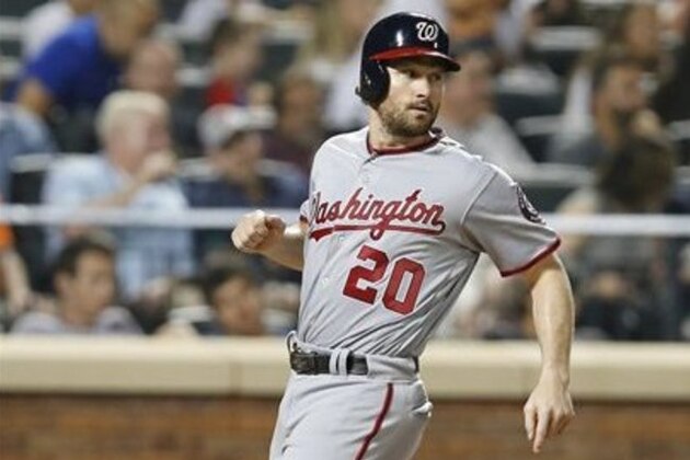 Washington Nationals' Daniel Murphy (20) scores during a baseball game against the New York Mets, Thursday, July 7, 2016, in New York.  (AP Photo/Kathy Willens)