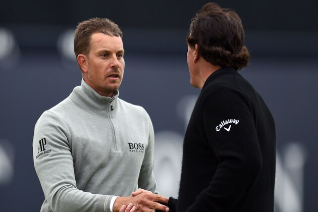 US golfer Phil Mickelson (R) and Sweden's Henrik Stenson shakes hands on the 18th green after their third rounds on day three of the 2016 British Open Golf Championship at Royal Troon in Scotland on July 16, 2016.
Sweden's Henrik Stenson leads the British Open by a single shot from Phil Mickelson after the third round following his superb 68 on Saturday. Stenson, bidding to win his first major at the age of 40, had five birdies and two bogeys in his three-under-par round to move to 12-under for the championship.
 / AFP / GLYN KIRK / RESTRICTED TO EDITORIAL USE        (Photo credit should read GLYN KIRK/AFP/Getty Images)