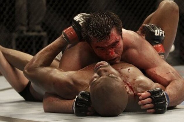 Chael Sonnen, top, competes against Anderson Silva during a UFC mixed martial arts match in Oakland, California, Saturday, August 7, 2010. Silva won by submission in the fifth round to retain the championship. (AP Photo/Jeff Chiu)
