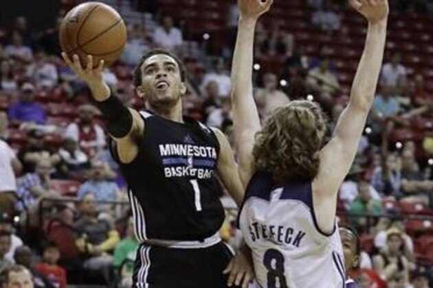 Minnesota Timberwolves' Tyus Jones shoots around Memphis Grizzlies' Keith Steffeck during the second half of an NBA summer league basketball game Thursday, July 14, 2016, in Las Vegas. (AP Photo/John Locher)