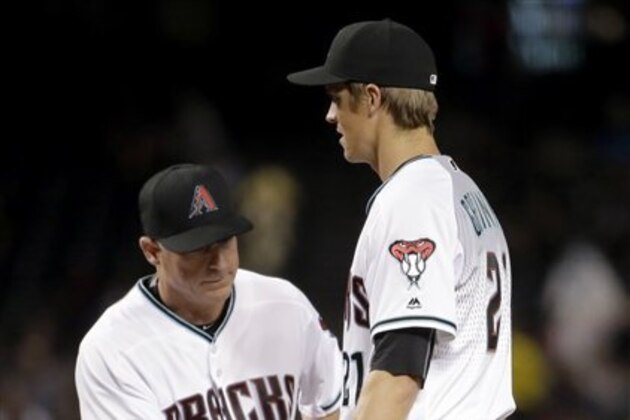 Arizona Diamondbacks manager Chip Hale (3) takes the ball from Arizona Diamondbacks Zack Greinke (21) after a stop in the game against the Philadelphia Phillies during the third inning of a baseball game, Tuesday, June 28, 2016, in Phoenix. Greinke was removed from the game. (AP Photo/Matt York)
