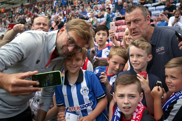 WIGAN, ENGLAND - JULY 17:  Jurgen Klopp manager of Liverpool takes a selfie with fans during the Pre-Season Friendly match between Wigan Athletic and Liverpool at JJB Stadium on July 17, 2016 in Wigan, England.  (Photo by Nigel Roddis/Getty Images)