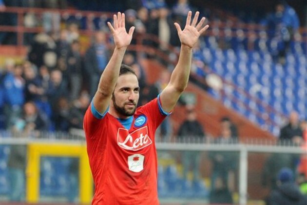 Napoli's Gonzalo Higuain celebrates with fans at the end of a Serie A soccer match between Sampdoria and Napoli, at the Genoa Luigi Ferraris stadium, Italy, Sunday, Jan. 24, 2016. League leader Napoli moved provisionally five points clear with a 4-2 win at 10-man Sampdoria on Sunday, ahead of Juventus' match against Roma as Inter Milan’s woes continued. (AP Photo/Carlo Baroncini)