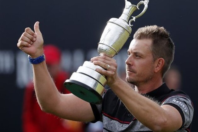Henrik Stenson of Sweden holds up the trophy tom the crowd after winning the British Open Golf Championships at the Royal Troon Golf Club in Troon, Scotland, Sunday, July 17, 2016. (AP Photo/Ben Curtis)