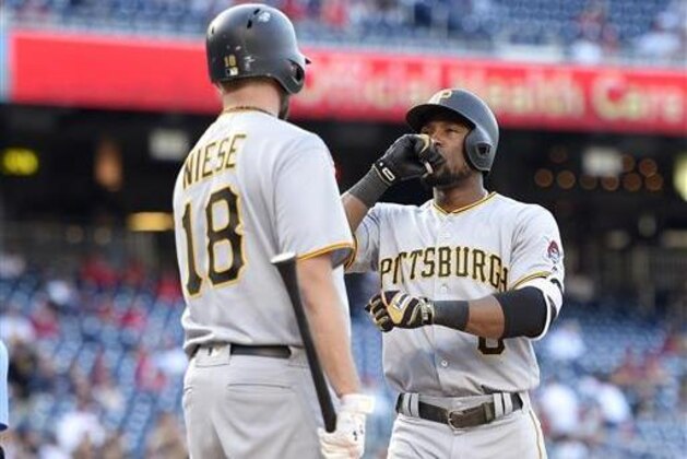Pittsburgh Pirates' Starling Marte, right, celebrates his home run with Jonathon Niese (18) during the 18th inning of a baseball game against the Washington Nationals, Sunday, July 17, 2016, in Washington. (AP Photo/Nick Wass)
