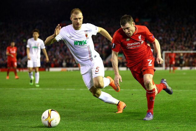 LIVERPOOL, ENGLAND - FEBRUARY 25:  James Milner of Liverpool and Ragnar Klavan of Augsburg compete for the ball during the UEFA Europa League Round of 32 second leg match between Liverpool and FC Augsburg at Anfield on February 25, 2016 in Liverpool, United Kingdom.  (Photo by Clive Brunskill/Getty Images)