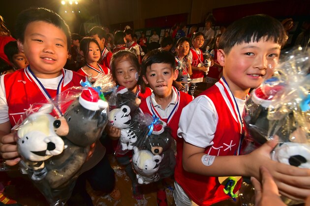 South Korean students hold the mascots for the 2018 Pyeongchang Winter Olympics, a white tiger named 'Soohorang' and an Asiatic black bear named 'Bandabi', during the mascots' first public staging event at Hoenggye elementary school in Pyeongchang, about 150 kms east of Seoul, on July 18, 2016.
The PyeongChang 2018 Organizing Committee announced a nationwide mascot promotion tour, plus a tour to the Rio Games for more active international promotion as well as a reach to major cities and festivals in South Korea. / AFP / JUNG YEON-JE        (Photo credit should read JUNG YEON-JE/AFP/Getty Images)