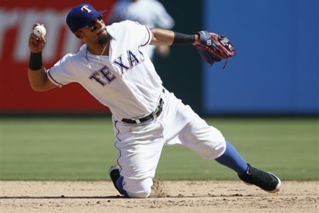 Texas Rangers second baseman Rougned Odor throws to first on a grounder by Minnesota Twins' Max Kepler during the seventh inning of a baseball game, Sunday, July 10, 2016, in Arlington, Texas. Kepler reached on a throwing error by Odor. (AP Photo/Jim Cowsert)