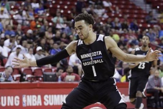 Memphis Grizzlies' Randy Culpepper, left, lies on the floor after fouling Minnesota Timberwolves' Tyus Jones during the second half of an NBA summer league basketball game Thursday, July 14, 2016, in Las Vegas. (AP Photo/John Locher)