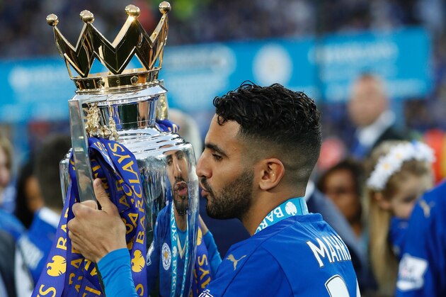Leicester City's Algerian midfielder Riyad Mahrez poses with the premier league trophy after winning the league and the English Premier League football match between Leicester City and Everton at King Power Stadium in Leicester, central England on May 7, 2016. / AFP / ADRIAN DENNIS / RESTRICTED TO EDITORIAL USE. No use with unauthorized audio, video, data, fixture lists, club/league logos or 'live' services. Online in-match use limited to 75 images, no video emulation. No use in betting, games or single club/league/player publications.  /         (Photo credit should read ADRIAN DENNIS/AFP/Getty Images)