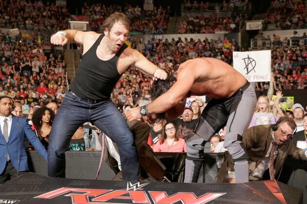Dean Ambrose and Seth Rollins fight on the announce table. Dean Ambrose and Seth Rollins fight on the announce table.