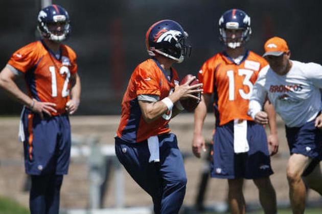 Denver Broncos quarterback Mark Sanchez, front, drops back to pass as, from back left, quarterbacks Paxton Lynch and Trevor Siemian and offensive coordinator Rick Dennison look on during an NFL football practice at the team's headquarters Tuesday, June 7, 2016, in Englewood, Colo. (AP Photo/David Zalubowski)