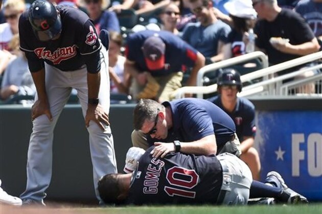 Cleveland Indians Yan Gomes is attended to by trainers after being injured during a play against the Minnesota Twins during the fifth inning of a baseball game Sunday, July 17, 2016, in Minneapolis. Gomes had to leave the game as the Indians win 6-1. (AP Photo/Craig Lassig)