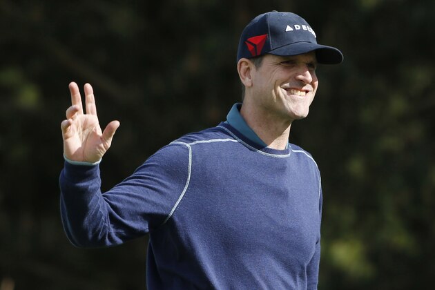 Feb 11, 2016; Pebble Beach, CA, USA; Michigan Wolverines football coach Jim Harbaugh waves during the first round of the AT&T Pebble Beach National Pro-Am at Spyglass Hill Golf Course. Mandatory Credit: Brian Spurlock-USA TODAY Sports