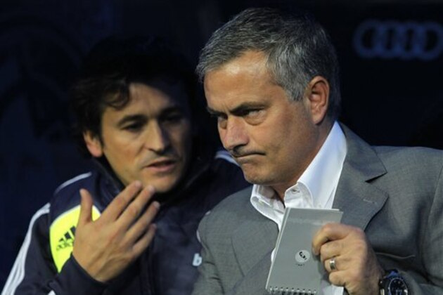 Real Madrid's coach Jose Mourinho from Portugal, right, and his assistant Rui Faria confer during a Spanish La Liga soccer match against Zaragoza at the Santiago Bernabeu stadium in Madrid, Spain, Saturday, Nov. 3, 2012. (AP Photo/Andres Kudacki)
