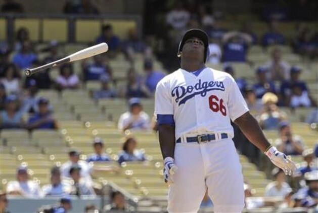 Los Angeles Dodgers' Yasiel Puig tosses his bat after he lined out during the 10th inning of a baseball game against the Baltimore Orioles, Wednesday, July 6, 2016, in Los Angeles. (AP Photo/Jae C. Hong)