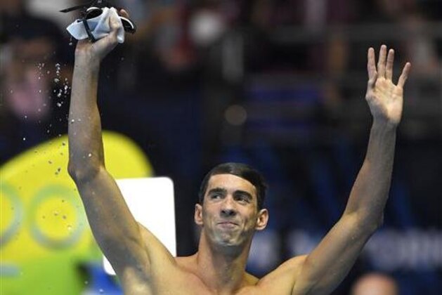 Michael Phelps waves to fans after the men's 100-meter butterfly at the U.S. Olympic swimming trials, Saturday, July 2, 2016, in Omaha, Neb. (AP Photo/Mark J. Terrill)