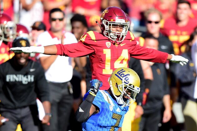 LOS ANGELES, CA - NOVEMBER 28:  Devin Fuller #7 of the UCLA Bruins reacsts to an incomplete pass on third down in front of Isaiah Langley #14 of the USC Trojans during the second quarter at Los Angeles Memorial Coliseum on November 28, 2015 in Los Angeles, California.  (Photo by Harry How/Getty Images)