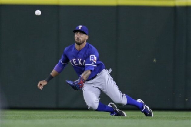 Texas Rangers left fielder Ian Desmond dives for a ball hit by Seattle Mariners' Robinson Cano during a baseball game Saturday, June 11, 2016, in Seattle. (AP Photo/John Froschauer)