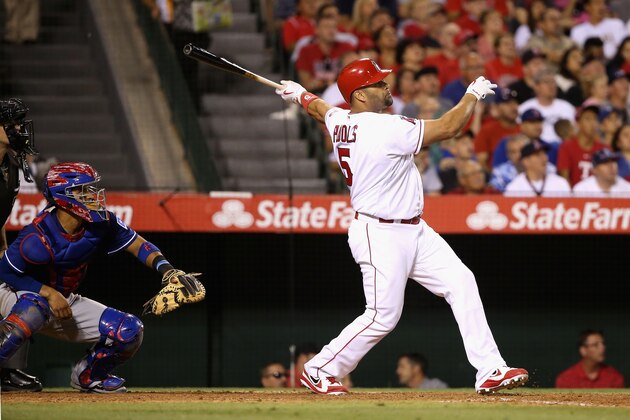 ANAHEIM, CA - JULY 19:  Albert Pujols #5 of the Los Angeles Angels of Anaheim watches the ball after hitting a three-run homerun during the fifth inning of a baseball game at Angel Stadium of Anaheim on July 19, 2016 in Anaheim, California. Robinson Chirinos #61 of the Texas Rangers looks on.  (Photo by Sean M. Haffey/Getty Images)