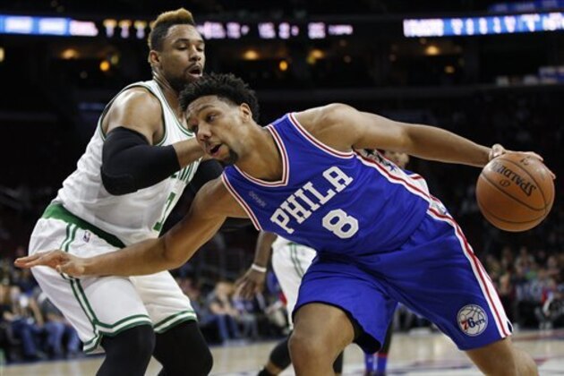 Philadelphia 76ers' Jahlil Okafor, right, in action against Boston Celtics' Jared Sullinger, left, during the first half of an NBA basketball game, Sunday, Jan. 24, 2016, in Philadelphia. The Celtics won 112-92. (AP Photo/Chris Szagola)