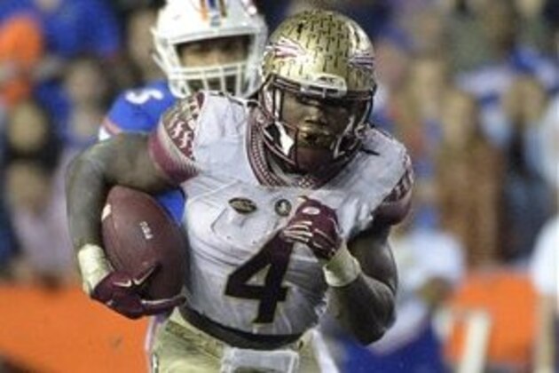 Florida State running back Dalvin Cook (4) rushes for yardage in front of Florida linebacker Antonio Morrison (3) during the second half of an NCAA college football game in Gainesville, Fla., Saturday, Nov. 28, 2015. Florida State won 27-2. (AP Photo/Phelan M. Ebenhack)