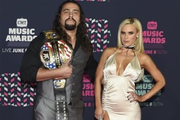 Professional wrestler Alexander Rusev, left, and Lana arrive at the CMT Music Awards at the Bridgestone Arena on Wednesday, June 8, 2016, in Nashville, Tenn. (Photo by Sanford Myers/Invision/AP)