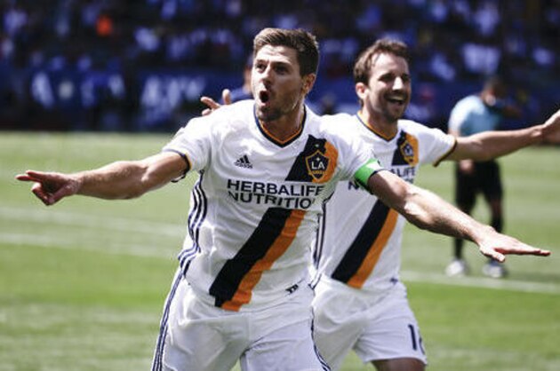 Los Angeles Galaxy midfielder Steven Gerrard, left, celebrates his goal with Mike Magee during the second half of an MLS soccer game against the New England Revolution on Sunday, May 8, 2016 in Carson, Calif. (AP Photo/Chris Carlson)