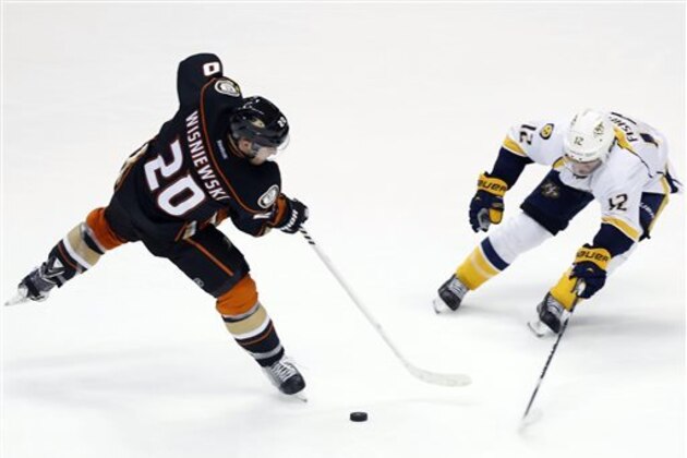 Nashville Predators Mike Fisher, right, defends as Anaheim Ducks' James Wisniewski tries to pass the puck in the third period of an NHL hockey game in Anaheim, Calif., Sunday, March 15, 2015. The Ducks won 4-2. (AP Photo/Christine Cotter)