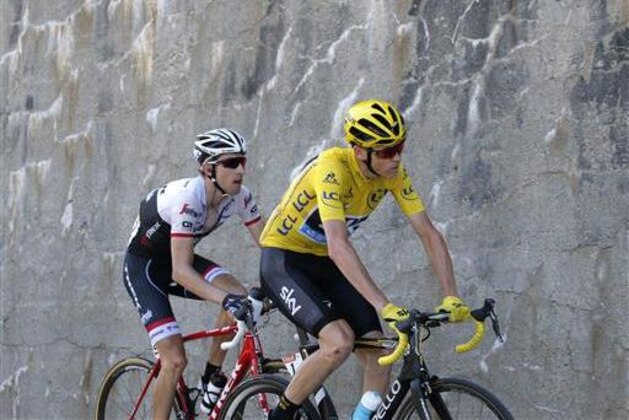 Netherlands' Bauke Mollema and Britain's Chris Froome, wearing the overall leader's yellow jersey, climb during the seventeenth stage of the Tour de France cycling race over 184.5 kilometers (114.3 miles) with start in Bern and finish in Finhaut-Emosson, Switzerland, Wednesday, July 20, 2016. (AP Photo/Christophe Ena)