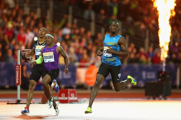 LONDON, ENGLAND - JULY 24:  Usain Bolt of Jamaica (r) crosses the line to win the Mens 100m Final during day one of the Sainsbury's Anniversary Games at The Stadium - Queen Elizabeth Olympic Park on July 24, 2015 in London, England.  (Photo by Paul Gilham/Getty Images)