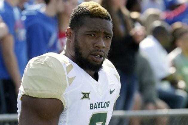 FILE - In this Oct. 10, 2015, file photo, then-Baylor defensive end Shawn Oakman warms up before an NCAA college football game against Kansas in Lawrence, Kan. NFL prospect and former Baylor football player Oakman was arrested Wednesday, April 13, 2016, on a charge of sexually assaulting a woman at his Texas apartment earlier this month, Waco police said Wednesday. (AP Photo/Charlie Riedel, File)