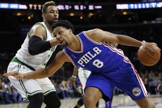 Philadelphia 76ers' Jahlil Okafor, right, in action against Boston Celtics' Jared Sullinger, left, during the first half of an NBA basketball game, Sunday, Jan. 24, 2016, in Philadelphia. The Celtics won 112-92. (AP Photo/Chris Szagola)