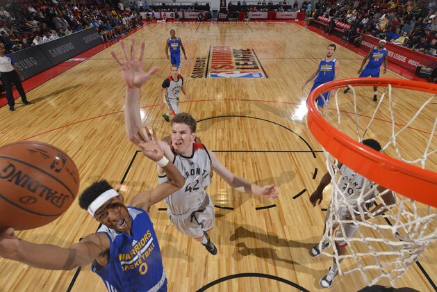 LAS VEGAS, NV - JULY 14:  Patrick McCaw #0 of the Golden State Warriors goes to the basket against Jakob Poeltl #42 of the Toronto Raptors during the 2016 NBA Las Vegas Summer League game on July 14, 2016 at the Cox Pavillion in Las Vegas, Nevada. NOTE TO USER: User expressly acknowledges and agrees that, by downloading and or using this photograph, User is consenting to the terms and conditions of the Getty Images License Agreement. Mandatory Copyright Notice: Copyright 2016 NBAE  (Photo by David Dow/NBAE via Getty Images)
