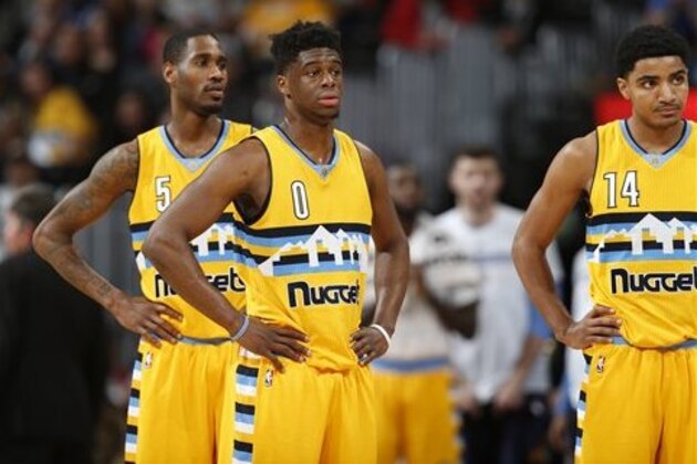 From left, Denver Nuggets forward Will Barton (5), Denver Nuggets guard Emmanuel Mudiay (0) and Denver Nuggets guard Gary Harris (14) in the second half of an NBA basketball game Friday, March 4, 2016, in Denver. Brooklyn won 121-120 in overtime. (AP Photo/David Zalubowski)
