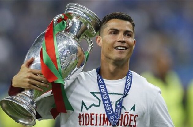 Portugal's Cristiano Ronaldo poses with the trophy at the end of the Euro 2016 final soccer match between Portugal and France at the Stade de France in Saint-Denis, north of Paris, Sunday, July 10, 2016. Portugal won 1-0. (AP Photo/Frank Augstein) Portugal's Cristiano Ronaldo poses with the trophy at the end of the Euro 2016 final soccer match between Portugal and France at the Stade de France in Saint-Denis, north of Paris, Sunday, July 10, 2016. Portugal won 1-0. (AP Photo/Frank Augstein)