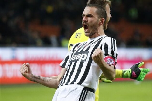 Juventus' Leonardo Bonucci celebrates past his teammate goalkeeper Neto after scoring the decisive goal that gave his team a 5-3 win over Inter Milan after a penalty shootout, during an Italian Cup second leg semifinal soccer match, at the San Siro stadium in Milan, Italy, Wednesday, March 2, 2016. (AP Photo/Antonio Calanni)