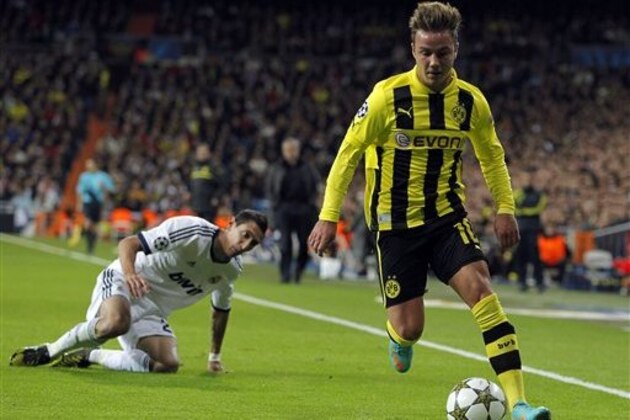 Real Madrid's Angel Di Maria from Argentina, left, competes with Borussia Dortmund's Mario Gotze, right, during a Group D Champions League soccer match at the Santiago Bernabeu stadium in Madrid, Spain, Tuesday, Nov. 6, 2012. (AP Photo/Andres Kudacki)