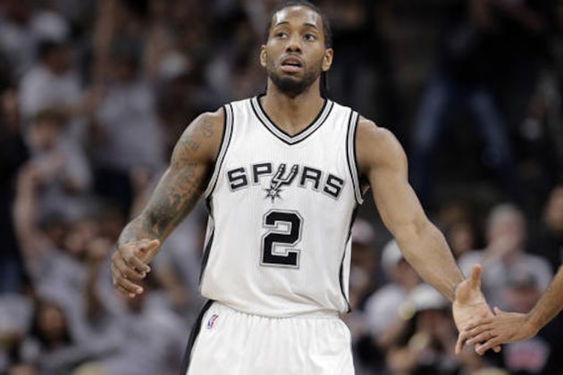 San Antonio Spurs forward Kawhi Leonard (2) reaches out to a teammate after he score against the Oklahoma City Thunder during the first half in Game 1 of a second-round NBA basketball playoff series, Saturday, April 30, 2016, in San Antonio. (AP Photo/Eric Gay)