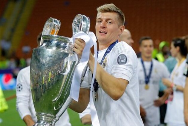 Real Madrid's Toni Kroos celebrates with the trophy after the Champions League final soccer match between Real Madrid and Atletico Madrid at the San Siro stadium in Milan, Italy, Saturday, May 28, 2016. Real Madrid won 5-3 on penalties after the match ended 1-1 after extra time.     (AP Photo/Manu Fernandez)