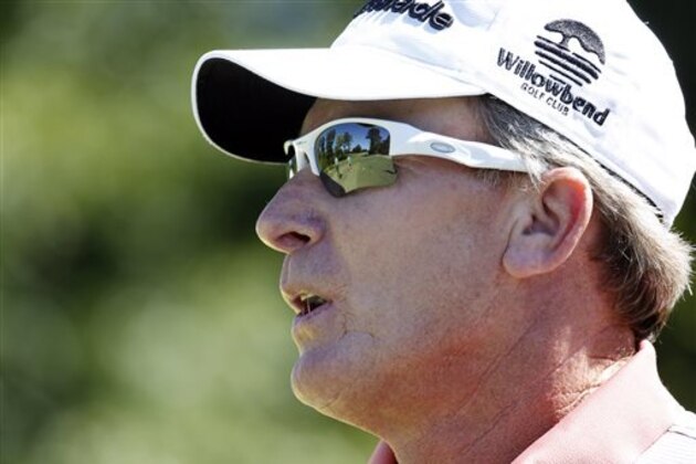 Woody Austin, the 2013 Sanderson Farms Championship winner, watches as members of his media golfing group tee off at the Country Club of Jackson, where the PGA Tour event has relocated, Monday, Sept. 22, 2014, in Jackson, Miss. After 18 years at Annandale Golf Course in Madison, the state's only regular PGA Tour event relocated to Jackson. (AP Photo/Rogelio V. Solis)