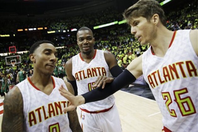Atlanta Hawks' Paul Millsap, center, joins teammates Jeff Teague, left, and Kyle Korver as they walk off the court after the Hawks beat the Boston Celtics 102-101 in Game 1 of a first-round NBA basketball playoff series Saturday, April 16, 2016, in Atlanta. (AP Photo/David Goldman)