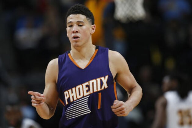 Phoenix Suns guard Devin Booker reacts after hitting a 3-point shot against the Denver Nuggets during the second half of an NBA basketball game Thursday, March 10, 2016, in Denver. The Nuggets won 116-98. (AP Photo/David Zalubowski)