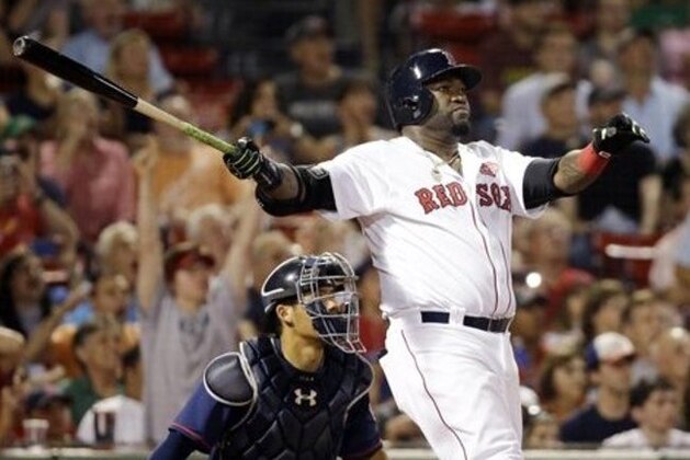 Boston Red Sox designated hitter David Ortiz follows through on a 2-run homer in front of Minnesota Twins catcher Kurt Suzuki in the eighth inning of a baseball game at Fenway Park, Thursday, July 21, 2016, in Boston. (AP Photo/Elise Amendola)