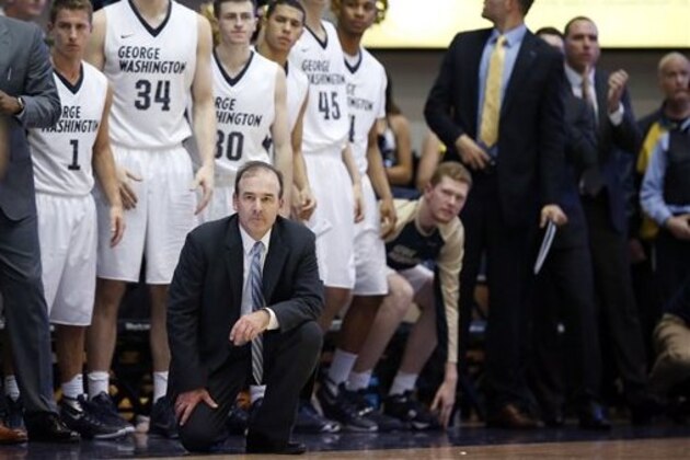 George Washington head coach Mike Lonergan kneels down to watch his team during the second half of an NCAA college basketball game against Virginia, Monday, Nov. 16, 2015, in Washington. George Washington won 73-68. (AP Photo/Alex Brandon)