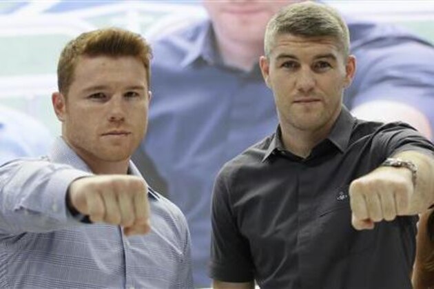 Canelo Alvarez, left, and Liam Smith pose for photos during a news conference promoting their upcoming fight at the stadium in Arlington, Texas, Monday, July 18, 2016. The pair will fight for the BBO Junior Middleweight Championship on Saturday, Sept. 17, 2016. (AP Photo/LM Otero)