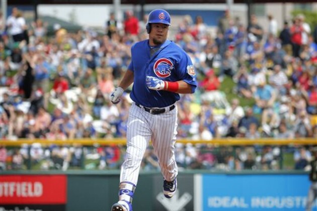 Chicago Cubs' Kyle Schwarber (12) rounds the bases after hitting a solo home run during the first inning of a spring training baseball game against the Oakland Athletics, Tuesday, March 29, 2016, in Mesa, Ariz. (AP Photo/Matt York)