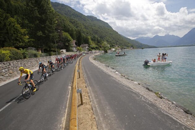 The pack with Britain's Chris Froome, wearing the overall leader's yellow jersey, rides along Annecy Lake during the nineteenth stage of the Tour de France cycling race over 146 kilometers (90.7 miles) with start in Albertville and finish in Saint-Gervais Mont Blanc, France, Friday, July 22, 2016. (AP Photo/Christophe Ena)