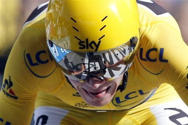 Britain's Chris Froome, wearing the overall leader's yellow jersey crosses the finish line to win the eighteenth stage of the Tour de France cycling race, an individual time trial over 17 kilometers (10.6 miles) with start in Sallanches and finish in Megeve, France, Thursday, July 21, 2016. (AP Photo/Christophe Ena)